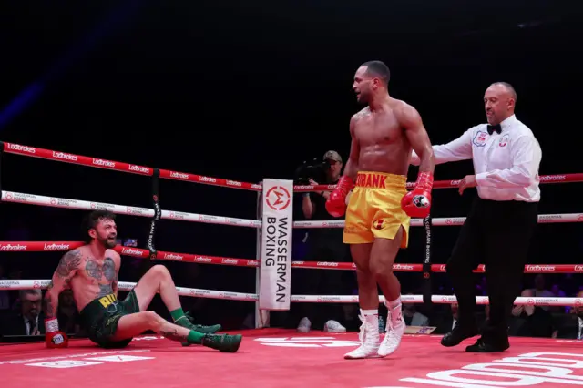 Tyrone McKenna on the canvas as the referee pulls Harlem Eubank away