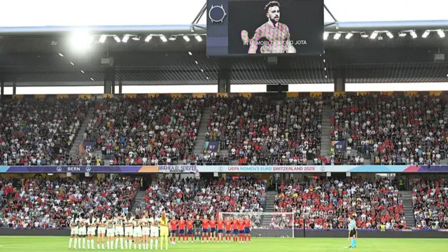Spain and Portugal gather around the centre-circle for a moment's silence before their match at the Women's Euros on Thursday