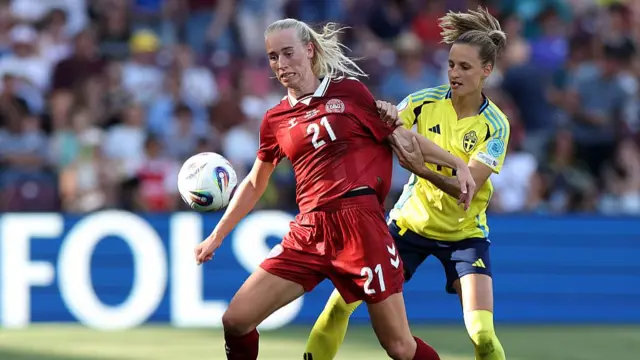 Amalie Vangsgaard of Denmark is challenged by Nathalie Bjoern of Sweden during the UEFA Women's EURO 2025 Group C match between Denmark and Sweden at Stade de Geneve