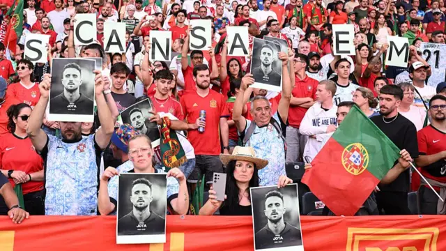 Portugal fans hold up pictures of Diogo Jota at their Women's Euros match against Spain