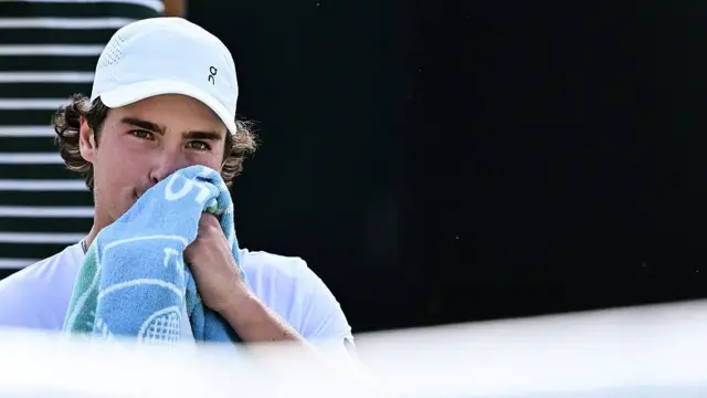 Joao Fonseca wipes his face