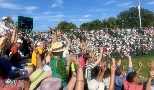 Fans do a Mexican wave