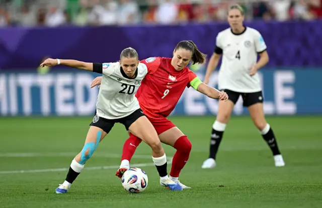 Elisa Senss of Germany is challenged by Ewa Pajor