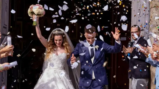 Diogo Jota and his wife walk out of church together