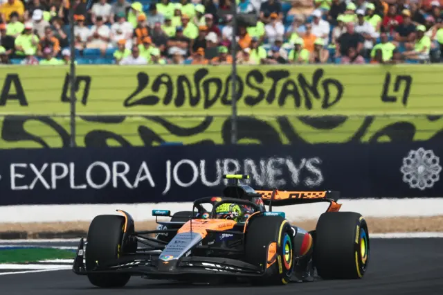 McLaren's Lando Norris in British Grand Prix second practice with the 'Lando stand' in the background