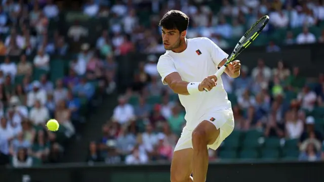 Carlos Alcaraz plays a backhand volley