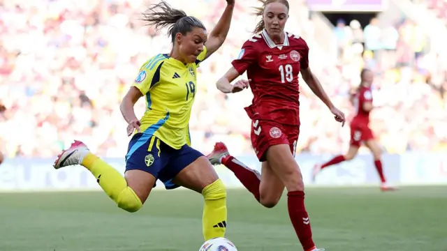 Johanna Rytting Kaneryd of Sweden runs with the ball under pressure from Sara Holmgaard of Denmark during the UEFA Women's EURO 2025 Group C match between Denmark and Sweden at Stade de Geneve