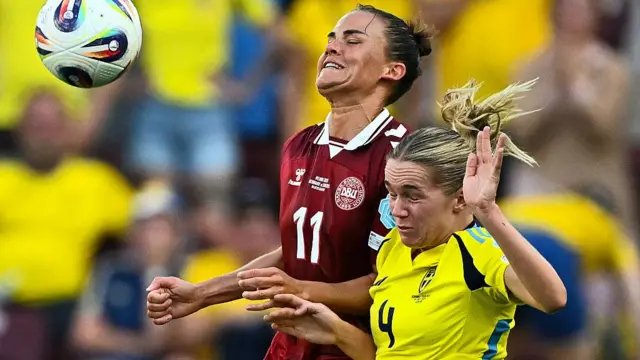 Denmark's defender #11 Katrine Veje fights for the ball with Sweden's defender #04 Hanna Lundkvist during the UEFA Women's Euro 2025 Group C football match between Denmark and Sweden at the Stade de Geneve