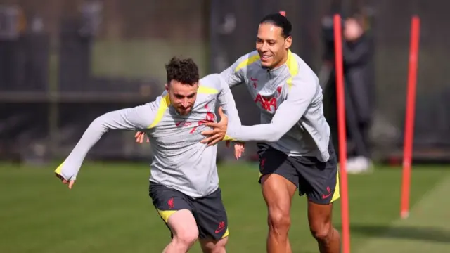 Virgil van Dijk chasing and pulling back Diogo Jota on a training pitch