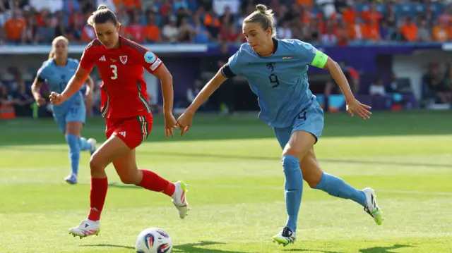 Netherlands' Vivianne Miedema in action with Wales' Gemma Evans