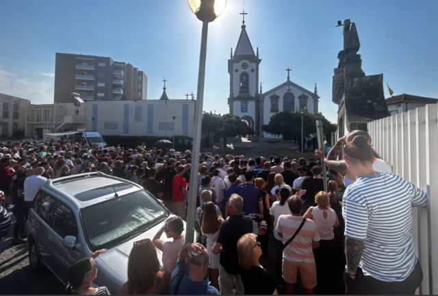 Hundreds gather in front of the church