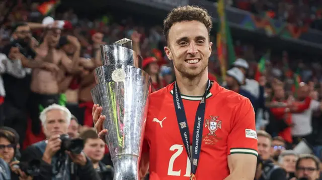Diogo Jota of Portugal poses for a photograph with the UEFA Nations League trophy