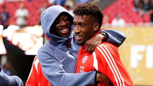 Kingsley Coman of FC Bayern Munchen greets Ousmane Dembele of Paris Saint-Germain