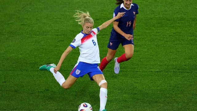 Leah Williamson of England shoots under pressure from Clara Mateo of France during the UEFA Women's EURO 2025 Group D match between France and England