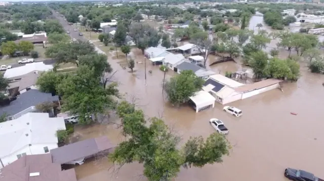 shows houses flooded following torrential rains that unleashed flash floods along the Guadalupe River in San Angelo