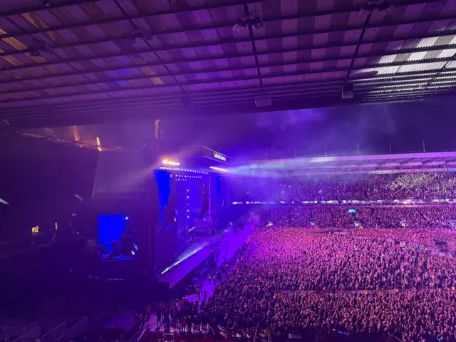 Crowd in purple light at rock concert