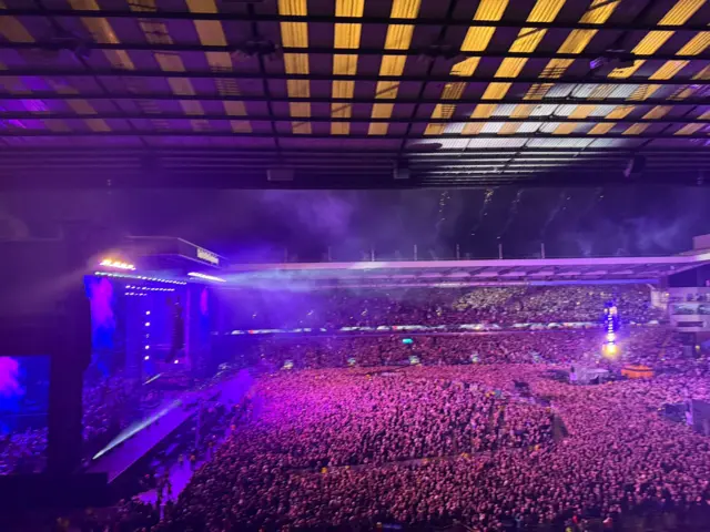 Crowd in purple light at rock concert