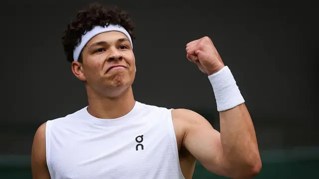 Ben Shelton celebrates after winning