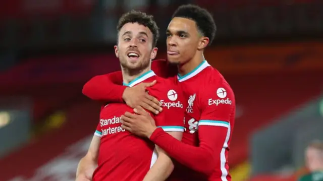 Diogo Jota of Liverpool celebrates with teammate Trent Alexander-Arnold