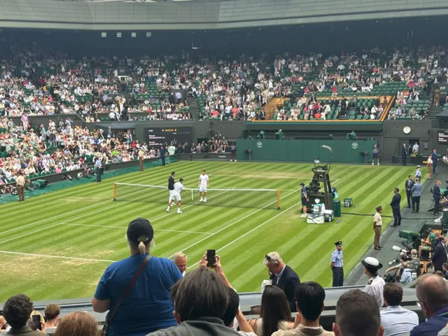 Novak Djokovic and Miomir Kecmanovic on Centre Court before their third-round match at Wimbledon