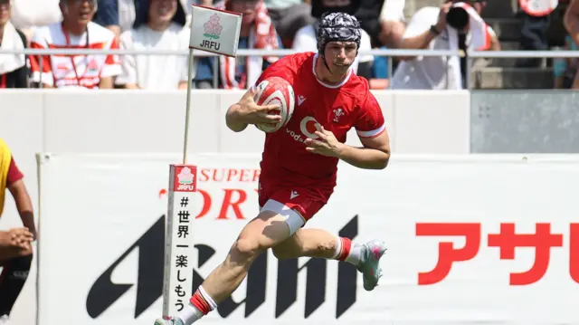 Tom Rogers runs in a try for Wales