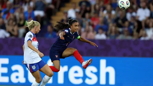 akina Karchaoui of France shoots under pressure from Alex Greenwood of England during the UEFA Women's EURO 2025 Group D match between France and England at Stadion Letzigrund