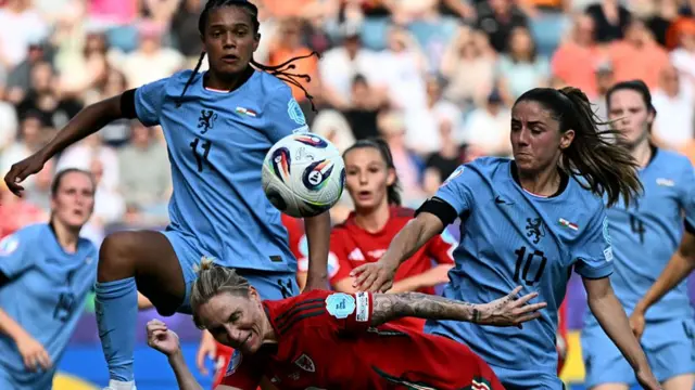 Wales' midfielder #10 Jessica Fishlock (bottom) fights for the ball with Netherlands' forward #11 Esmee Brugts (L) and Netherlands' midfielder #10 Danielle van de Donk (R) during the UEFA Women's Euro 2025 Group D football match between Wales and The Netherlands at the Allmend Stadion Luzern in Lucerne