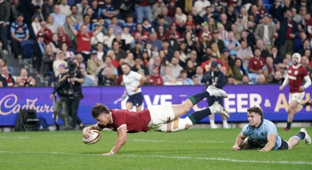 British and Irish Lions' Huw Jones (left) scores