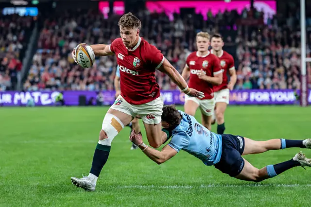 Huw Jones (L) runs with the ball