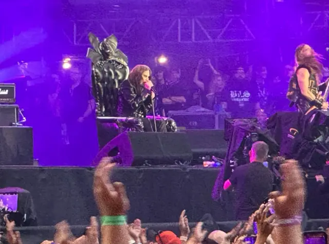 A man holding a microphone on stage.