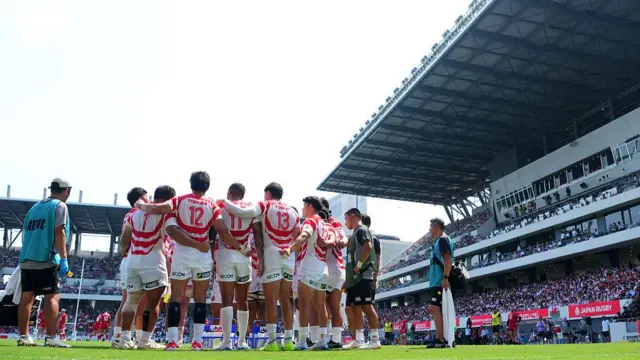 Japan in a huddle on the pitch