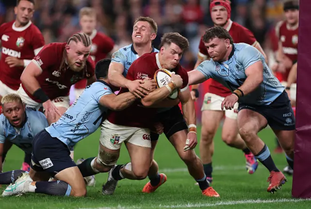 Huw Jones of the British & Irish Lions goes past the Waratah's defence