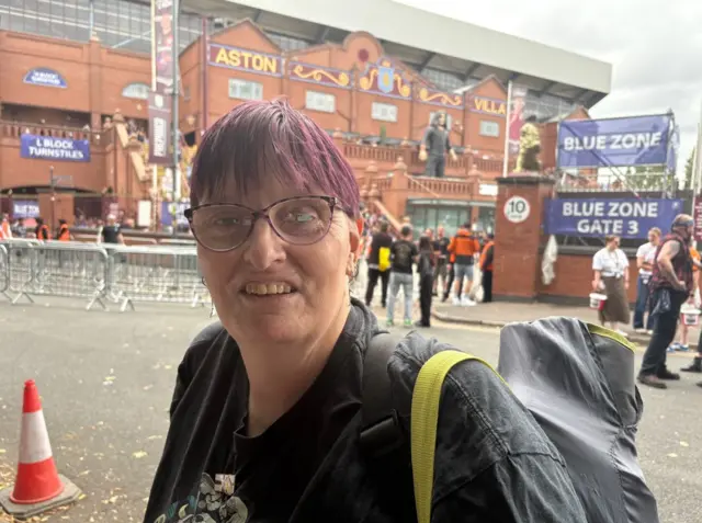 A woman with purple hair outside Villa Park