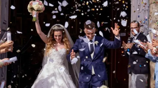 Rute Cardoso and Diogo Jota walking out of their wedding to confetti