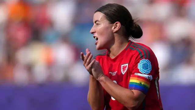 Angharad James-Turner of Wales gestures, while wearing the Rainbow UEFA Respect captains armband during the UEFA Women's EURO 2025 Group D match between Wales and Netherlands at Luzern Arena