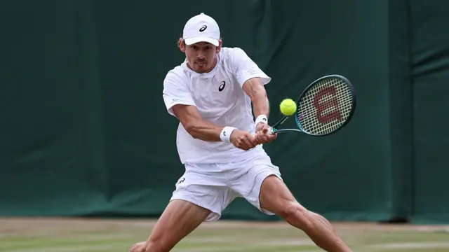 Alex De Minaur plays a backhand return