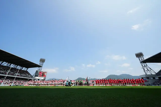 Teams line up for the anthems