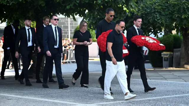Liverpool players carry wreaths