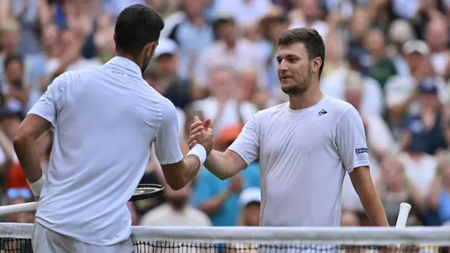 Novak Djokovic shakes hands with Miomir Kecmanovic