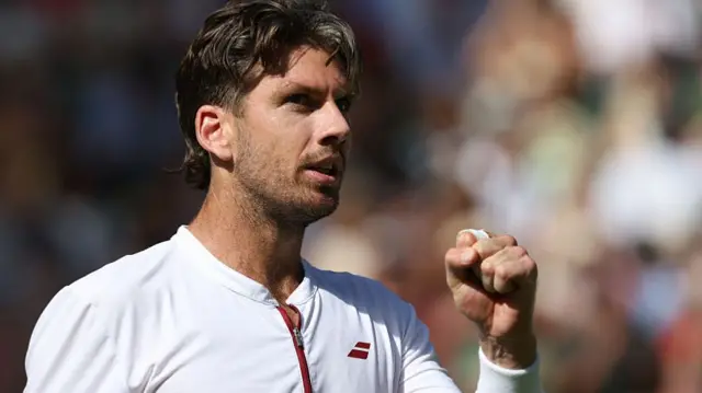 Cameron Norrie holds up his fist to celebrate