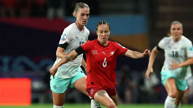 Gaeraldine Reuteler of Switzerland controls the ball under pressure from Dagny Brynjarsdottir of Iceland during the UEFA Women's EURO 2025 Group A match between Switzerland and Iceland