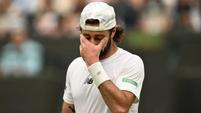 Jordan Thompson of Australia wipes his face