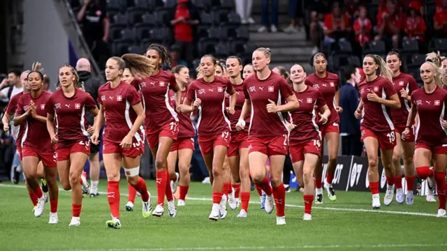 Swiss players warm-up prior to the start of the UEFA Women's Euro 2025 Group A football match between Switzerland and Iceland at the Wankdorf stadium in Bern