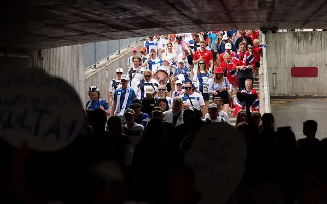Fans arrive at the stadium