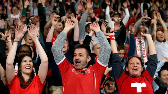 Fans of Switzerland preform a Mexican wave