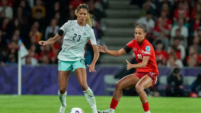 Sveindis Jonsdottir of Iceland (L) controls the ball under pressure from Iman Beney