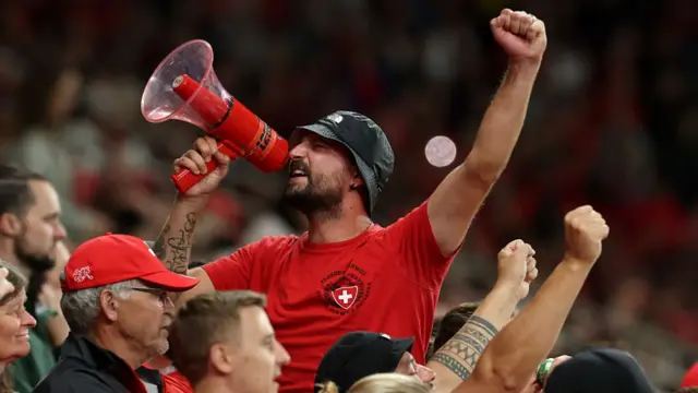 A fan of Switzerland uses a mega phone to engage with the crowd during the UEFA Women's EURO 2025 Group A match between Switzerland and Iceland at Stadion Wankdorf