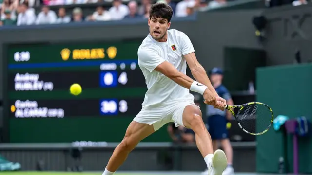 Carlos Alcaraz plays a backhand