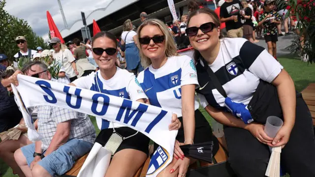 Fans of Finland pose for a photo, as they enjoy the pre-match atmosphere prior to the UEFA Women's EURO 2025 Group A match between Norway and Finland at Stade de Tourbillon