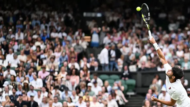 Carlos Alcaraz serves